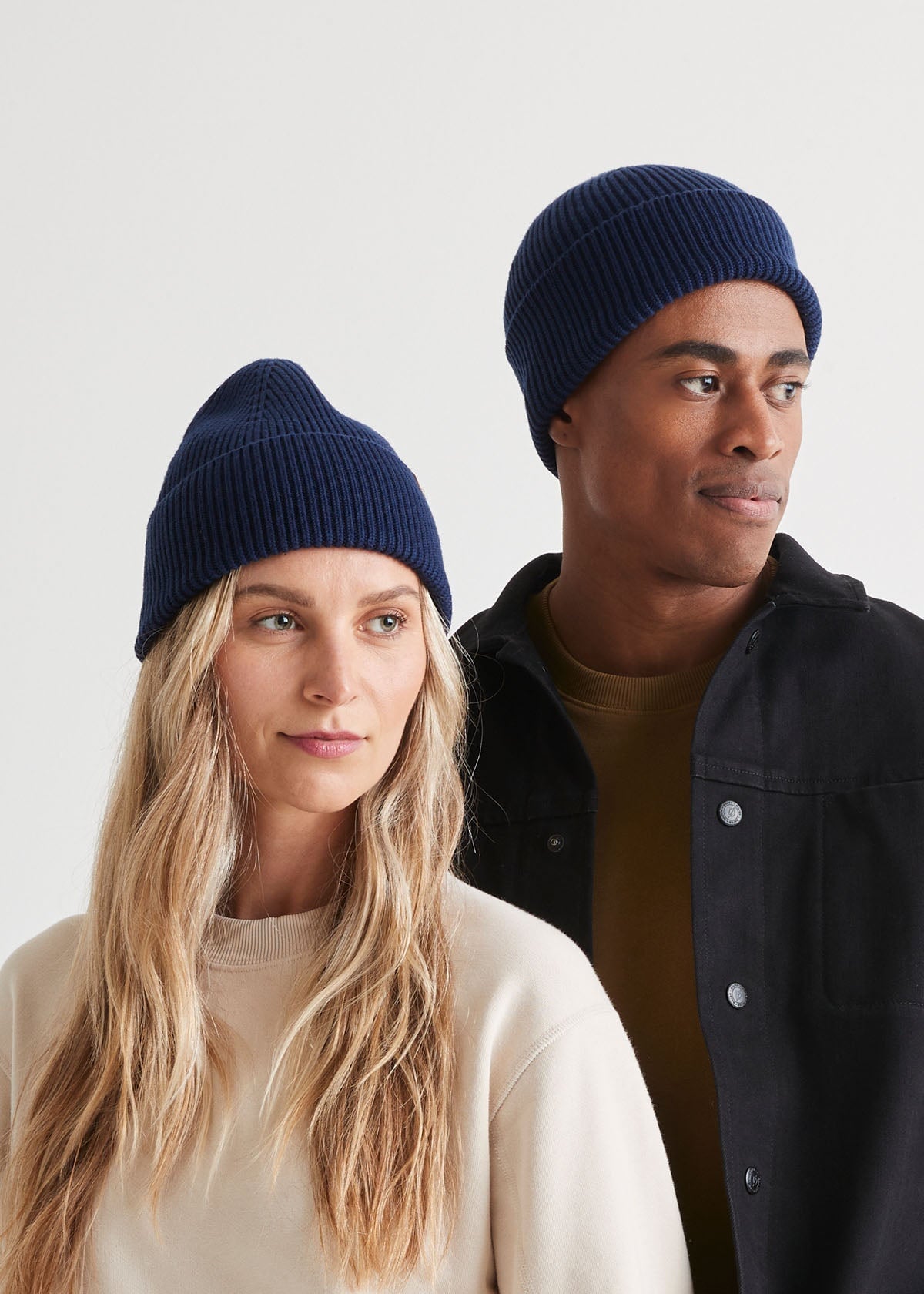 man and woman wearing unisex warm merino navy beanie