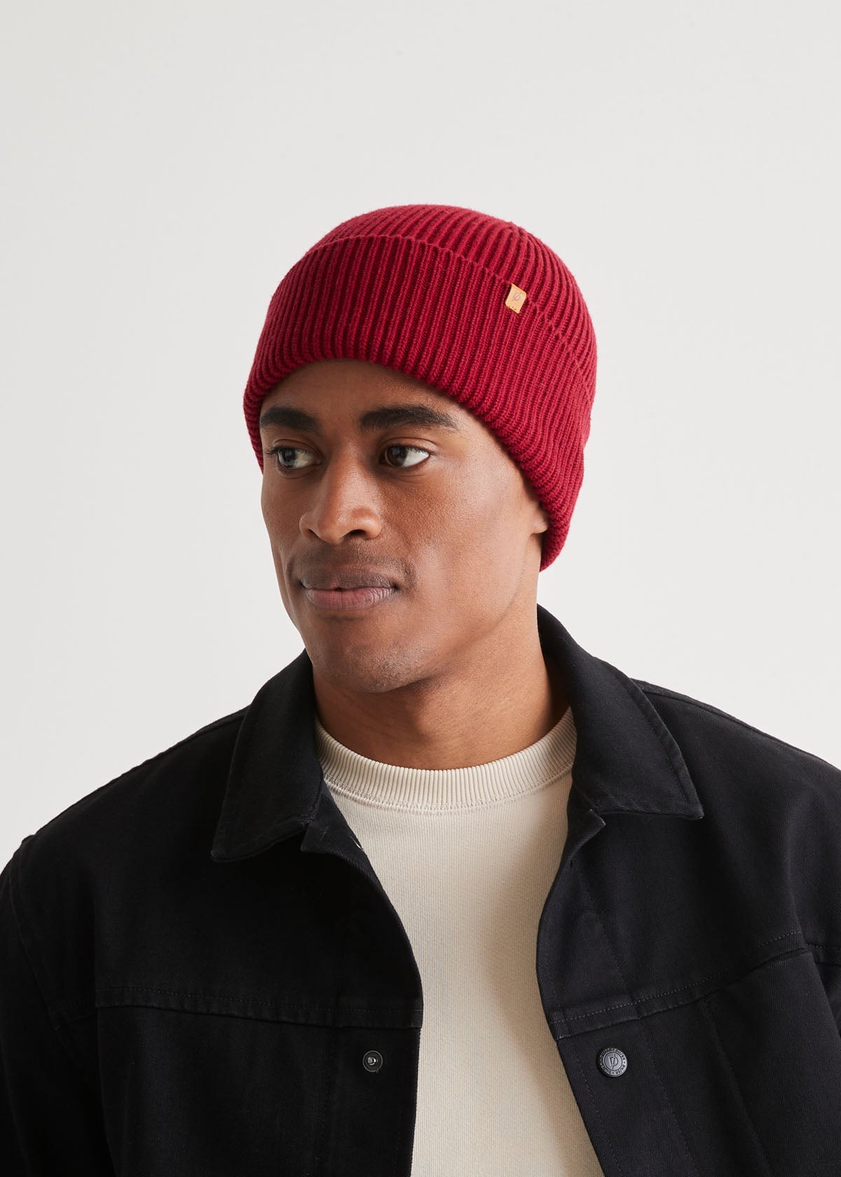 man wearing warm merino red beanie front