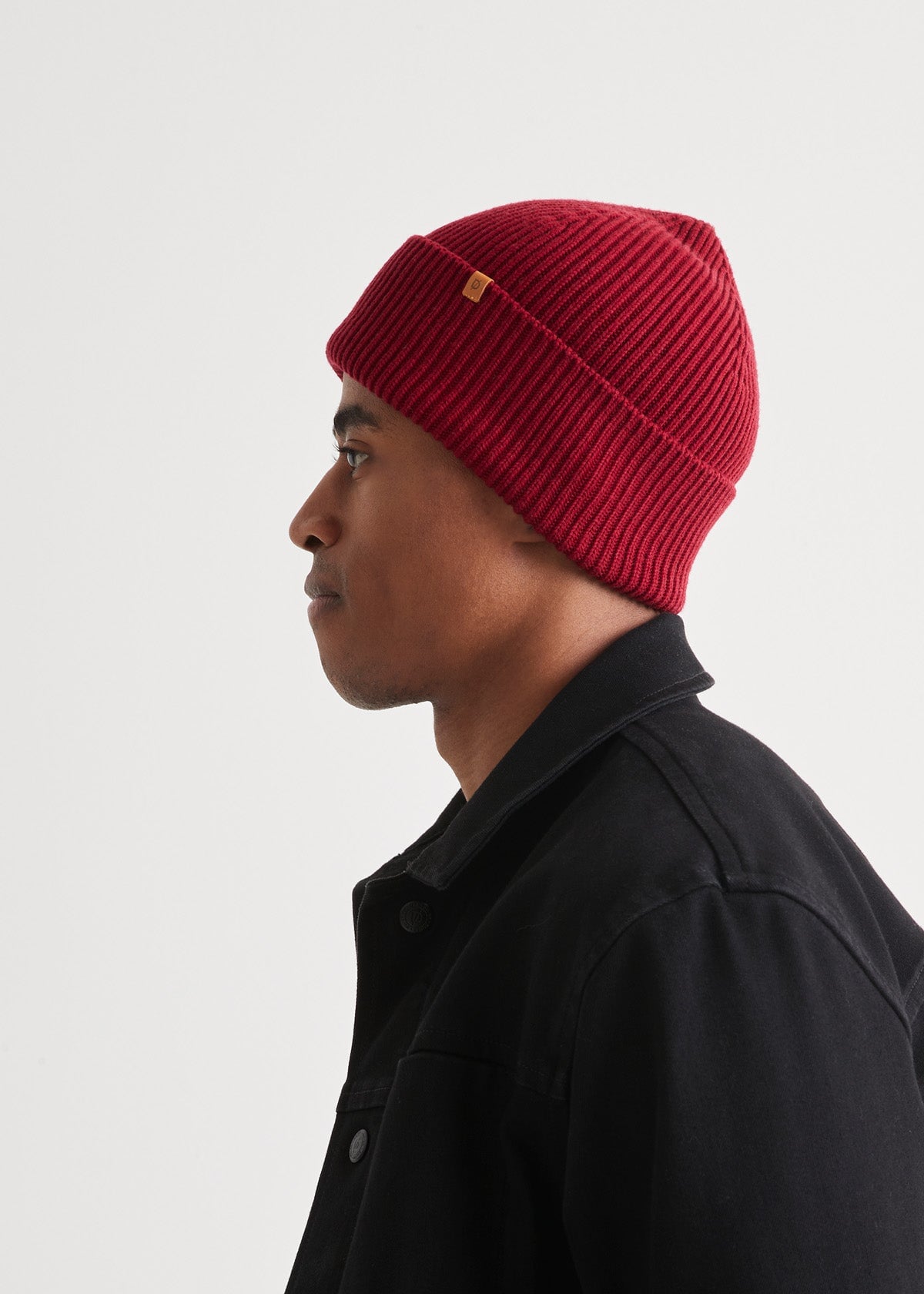 man wearing warm merino red beanie side