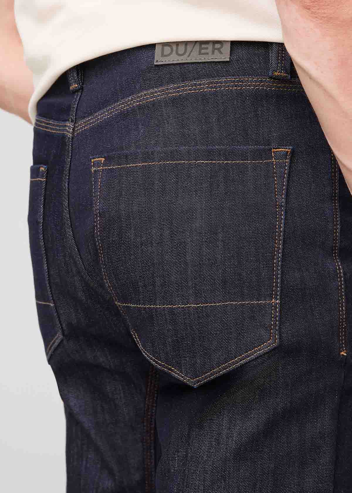 man wearing dark blue slim fit waterproof stretch jeans back patch and pocket