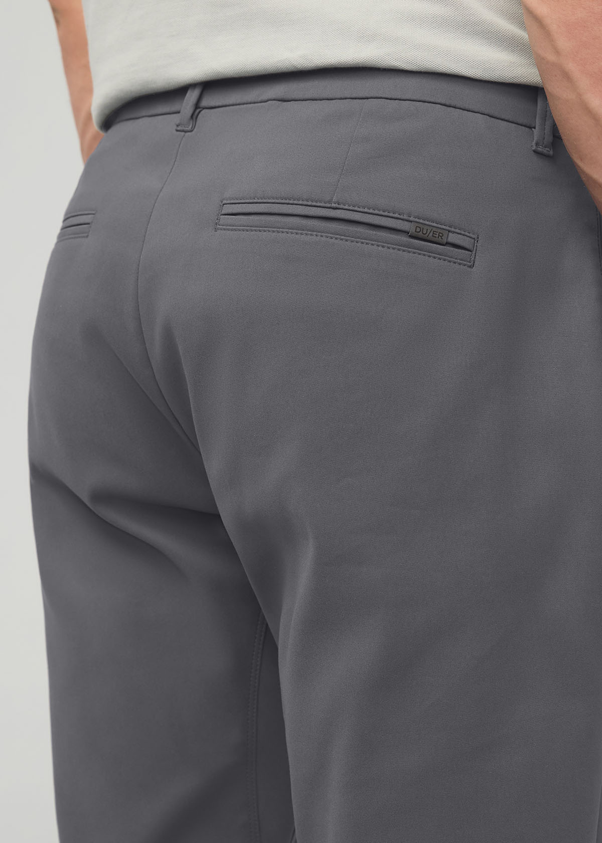 Gray relaxed taper trousers with back pocket detail, worn with a light gray t-shirt.