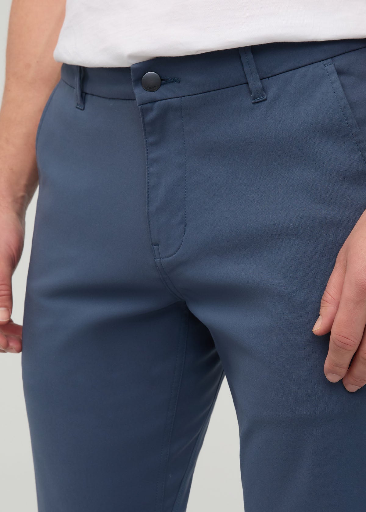 Heritage blue slim straight trousers with button waistband, worn with white shirt.