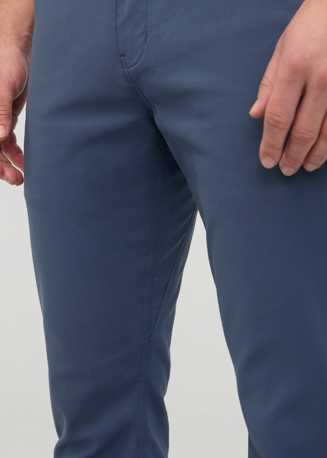Blue heritage slim straight trousers on model from waist to knee, showing fit and seam details.