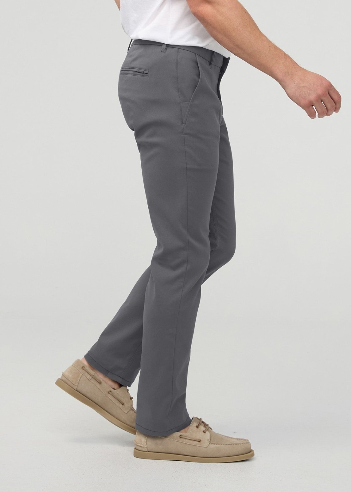 Gray slim straight trouser with flat front and pockets, worn with white shirt and tan boat shoes.