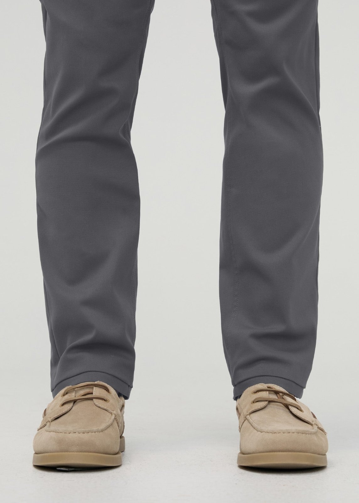 Gray straight-leg trousers with tapered ankles, styled with tan boat shoes.