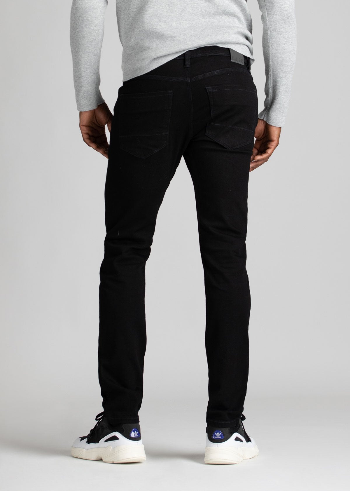 black water resistant slim jeans back view